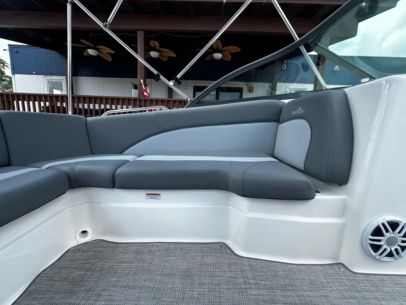 Slide: The Image of 2024 NauticStar 203 DC boat interior with gray seating and modern design. - 15