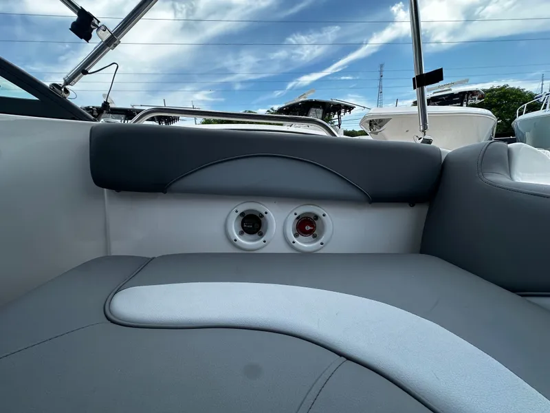 Slide: The Image of 2024 NauticStar 203 DC boat interior with gray seating and cup holders. - 17