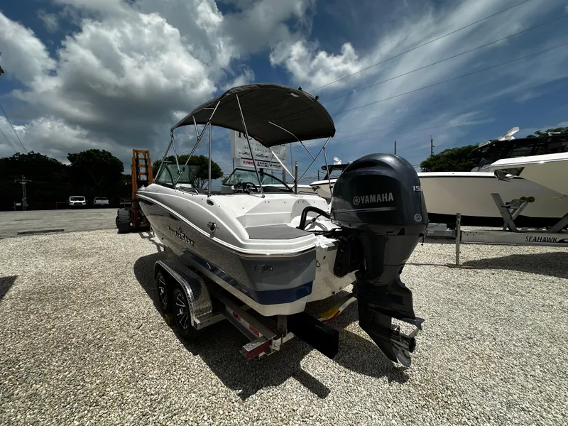 Slide: The Image of 2024 NauticStar 203 DC boat with Yamaha engine on trailer, parked outdoors. - 3