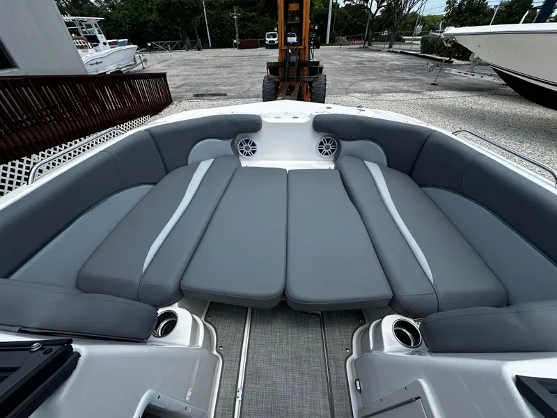 Slide: The Image of 2024 NauticStar 203 DC boat with spacious gray seating and cup holders. - 6