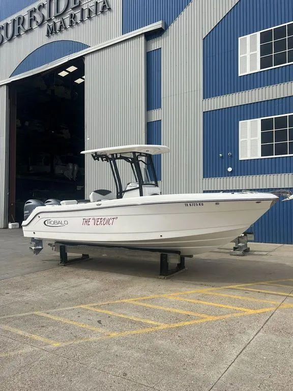 The Image of 2023 Robalo R242 boat outside marina building. - 1