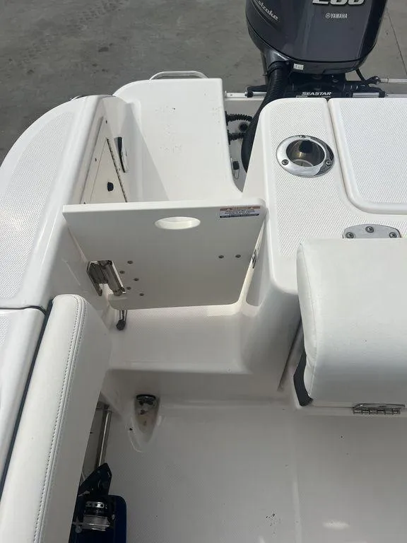 Slide: The Image of 2023 Robalo R242 boat interior with seating and motor detail. - 12