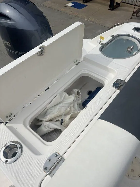 Slide: The Image of 2023 Robalo R242 boat storage compartment and engine detail. - 13
