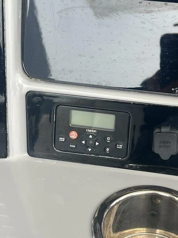 Slide: The Image of 2023 Robalo R242 boat dashboard with Clarion audio system. - 19