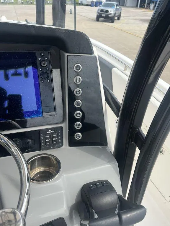 Slide: The Image of 2023 Robalo R242 boat dashboard with navigation controls and display. - 22