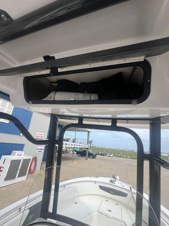 Slide: The Image of 2023 Robalo R242 boat interior with storage compartment, dockside view. - 25
