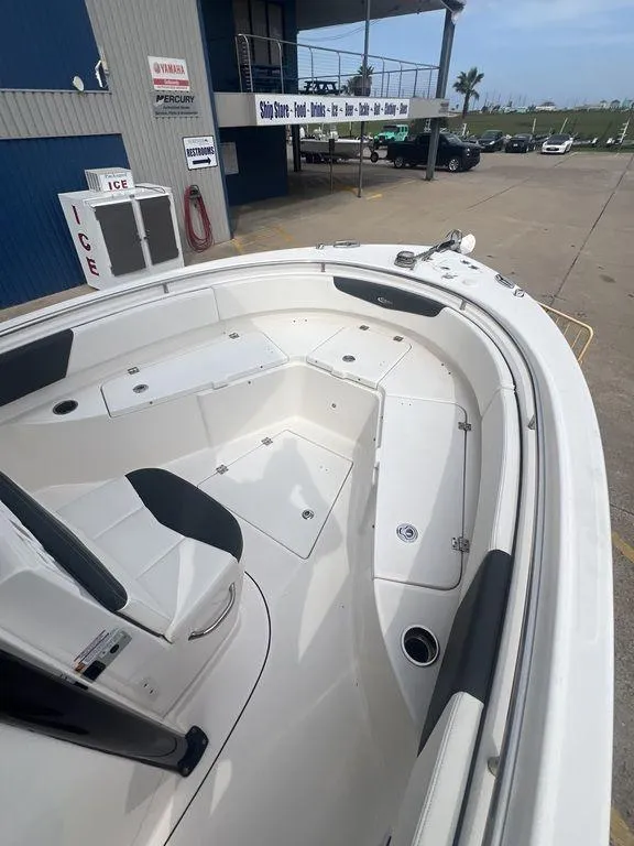 Slide: The Image of 2023 Robalo R242 boat deck, spacious seating, docked at marina. - 28