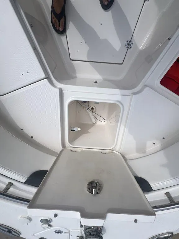 Slide: The Image of 2023 Robalo R242 boat interior with storage compartments and seating area. - 31