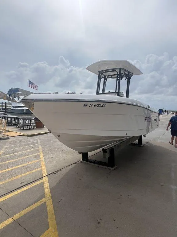 Slide: The Image of 2023 Robalo R242 boat on a dock under cloudy skies. - 9