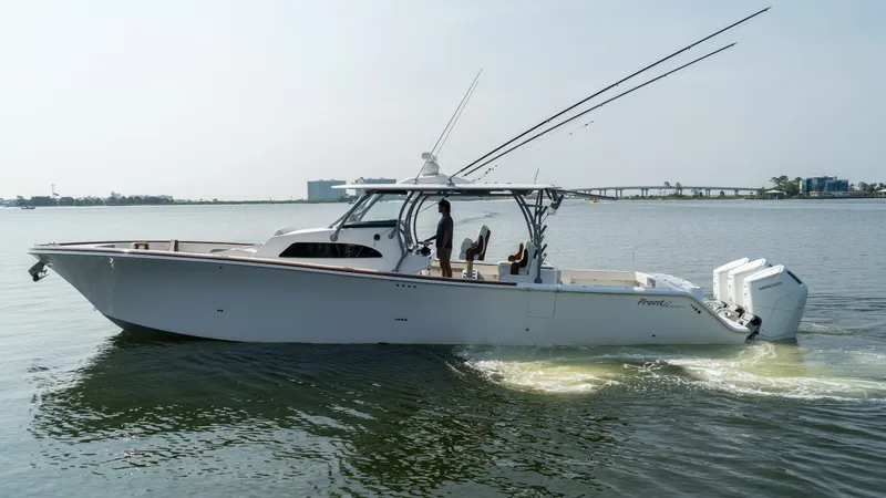 Slide: The Image of 2023 Front Runner 47 Center Console boat cruising on calm water. - 2
