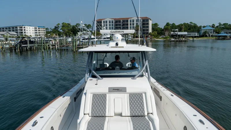 Slide: The Image of 2023 Front Runner 47 Center Console boat on calm water near marina. - 29
