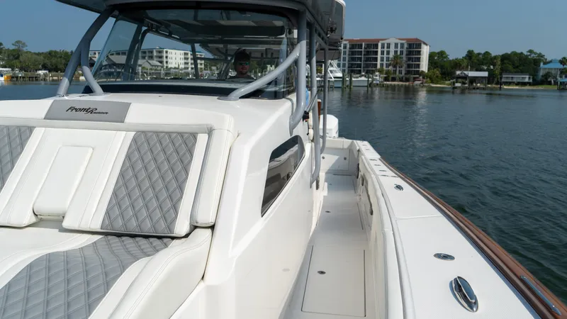 Slide: The Image of 2023 Front Runner 47 Center Console boat on water, featuring sleek design and luxury seating. - 32