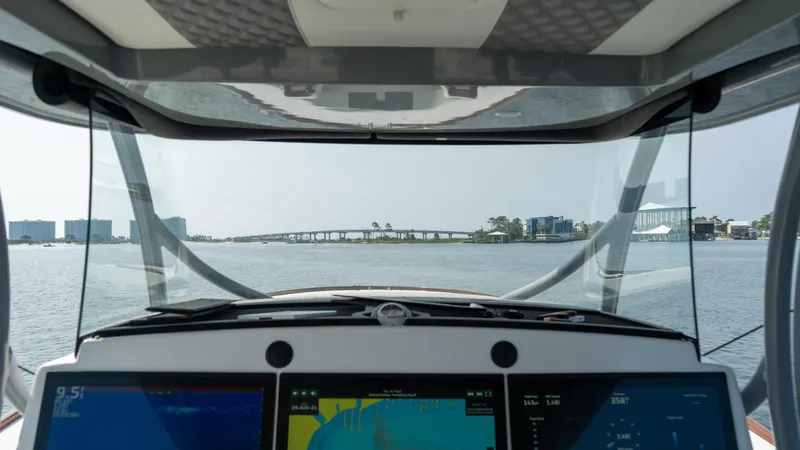 Slide: The Image of 2023 Front Runner 47 Center Console boat dashboard with navigation screens on open water. - 37