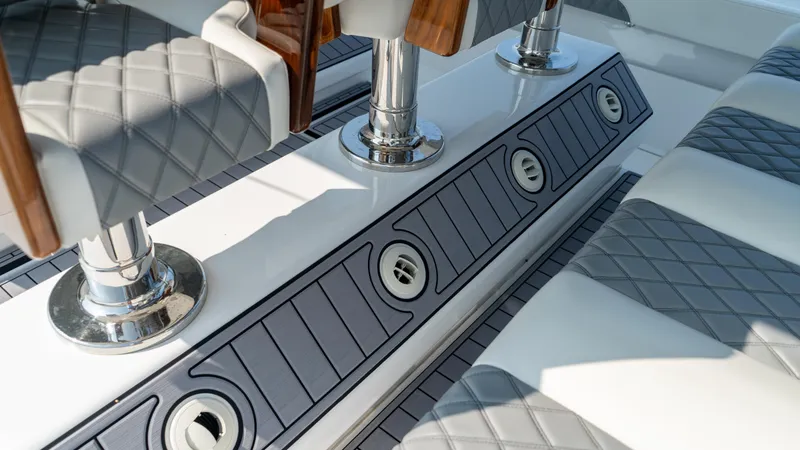 Slide: The Image of 2023 Front Runner 47 Center Console interior with quilted seating and chrome accents. - 41