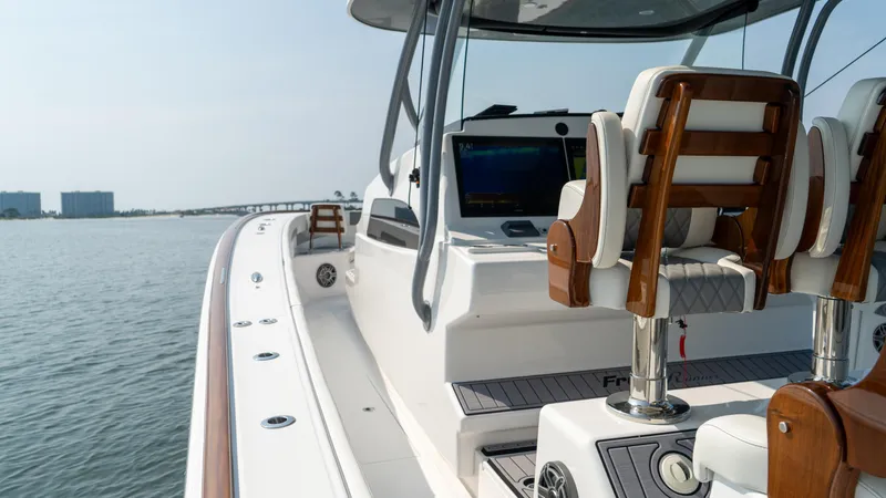 Slide: The Image of 2023 Front Runner 47 Center Console boat on calm water, featuring sleek design and modern seating. - 42
