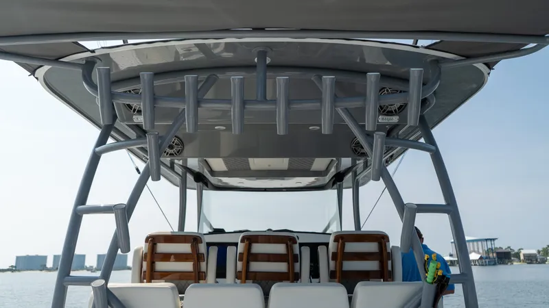 Slide: The Image of 2023 Front Runner 47 Center Console boat with rod holders and seating, on calm water. - 45