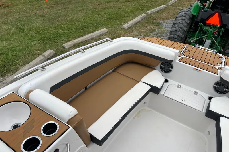 Slide: The Image of 2024 Starcraft SVX 211 OB boat interior with tan seating and cup holders. - 18