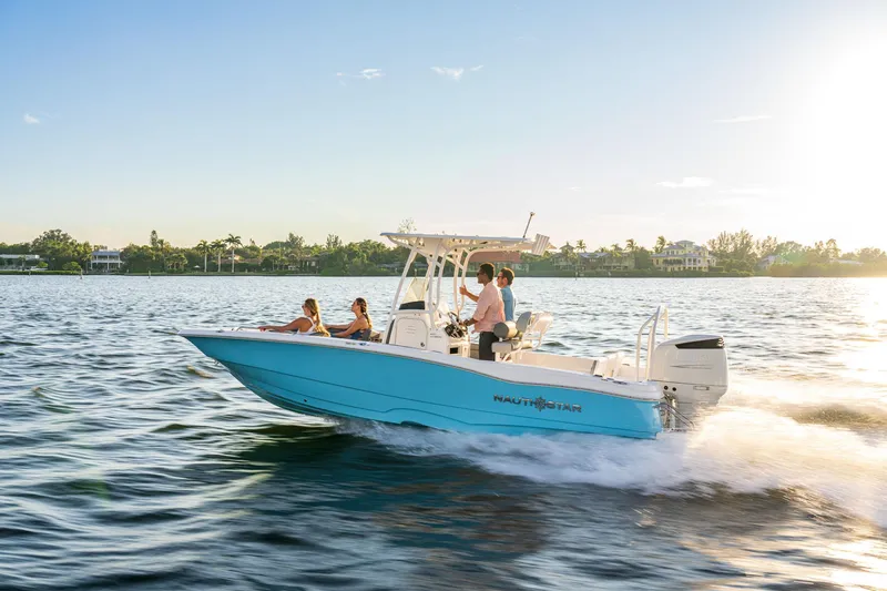 Slide: The Image of 2025 NauticStar 231 Hybrid boat cruising on a sunny day. - 10