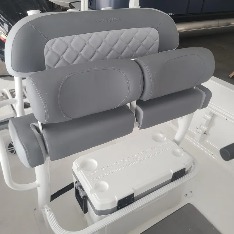 Slide: The Image of 2025 NauticStar 231 Hybrid boat seat with gray cushioning and integrated cooler. - 13