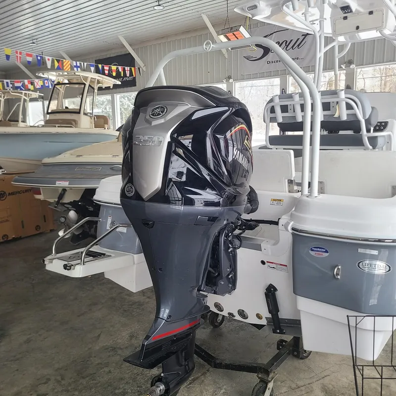 Slide: The Image of 2025 NauticStar 231 Hybrid boat with Yamaha outboard motor in showroom. - 18