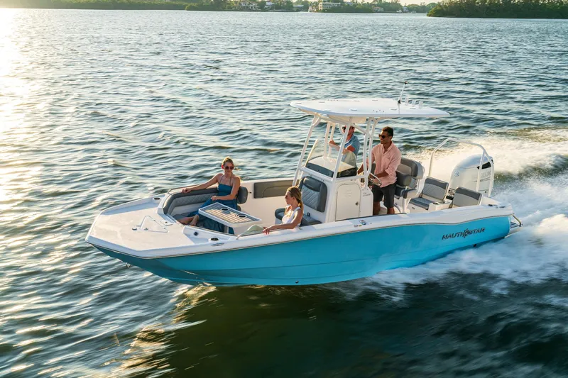 Slide: The Image of 2025 NauticStar 231 Hybrid boat cruising on open water with passengers. - 19