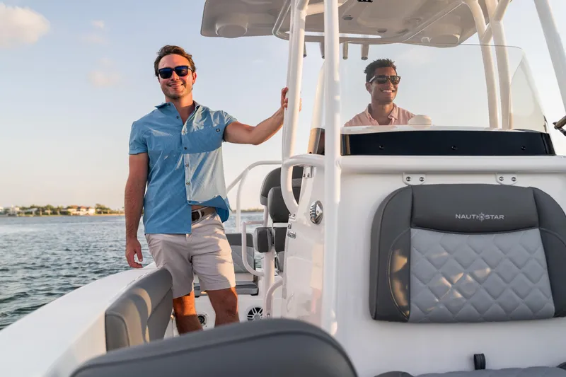 Slide: The Image of Two people enjoying a ride on a 2025 NauticStar 231 Hybrid boat. - 20