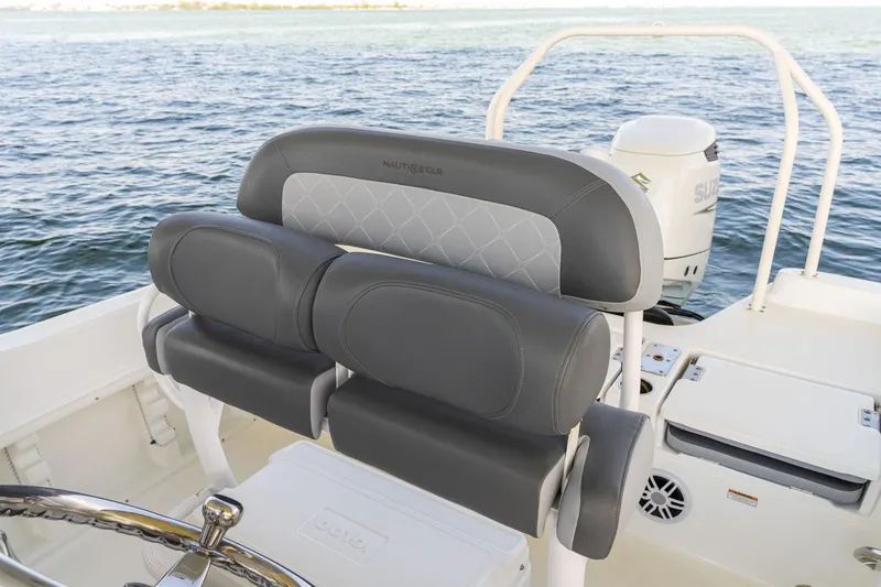 Slide: The Image of 2025 NauticStar 231 Hybrid boat interior with cushioned seating and steering wheel. - 25
