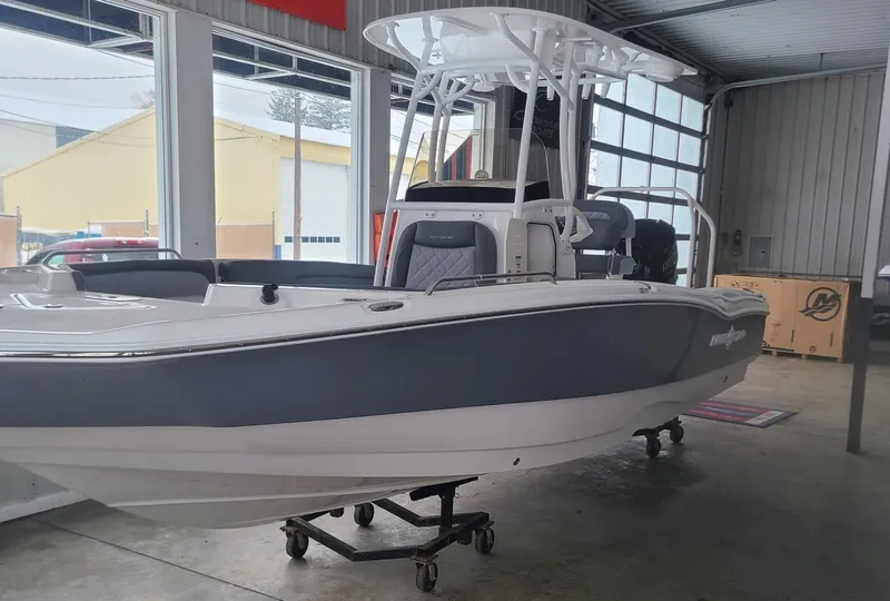 Slide: The Image of 2025 NauticStar 231 Hybrid boat in showroom, gray and white exterior. - 3