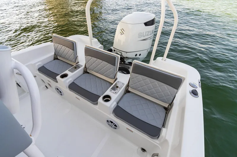 Slide: The Image of 2025 NauticStar 231 Hybrid boat seats with Suzuki outboard motor on water. - 30
