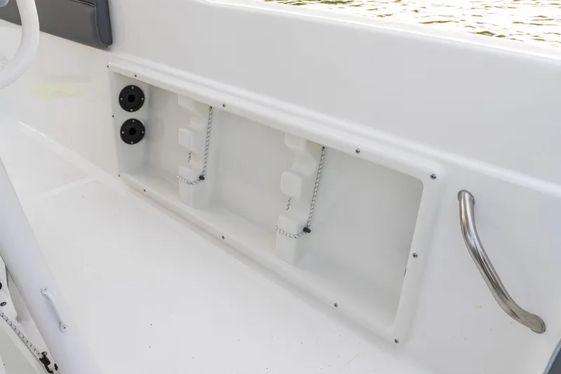 Slide: The Image of 2025 NauticStar 231 Hybrid boat interior detail with storage compartment and handle. - 32