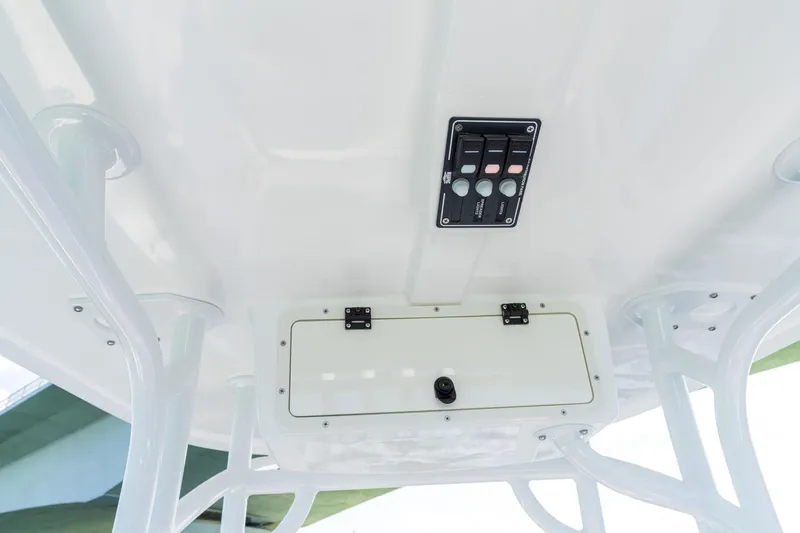Slide: The Image of 2025 NauticStar 231 Hybrid boat console with control panel and storage compartment. - 34