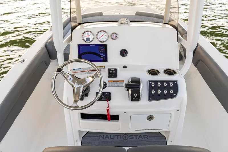 Slide: The Image of 2025 NauticStar 231 Hybrid boat console with steering wheel and controls. - 35