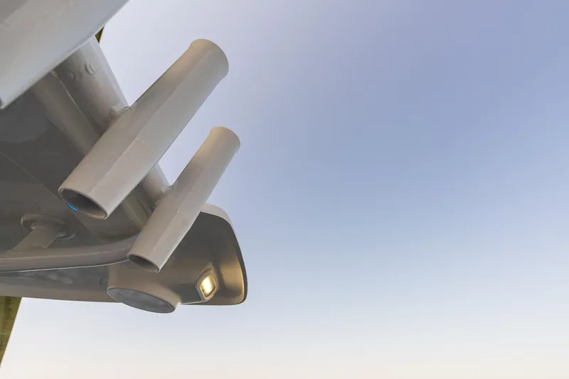 Slide: The Image of Close-up of 2025 NauticStar 231 Hybrid boat exhaust pipes against clear sky. - 36
