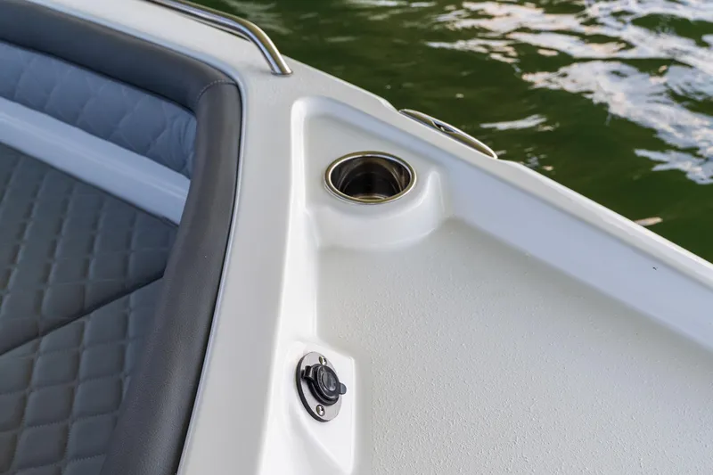 Slide: The Image of 2025 NauticStar 231 Hybrid boat interior with cup holder and cushioned seating. - 38