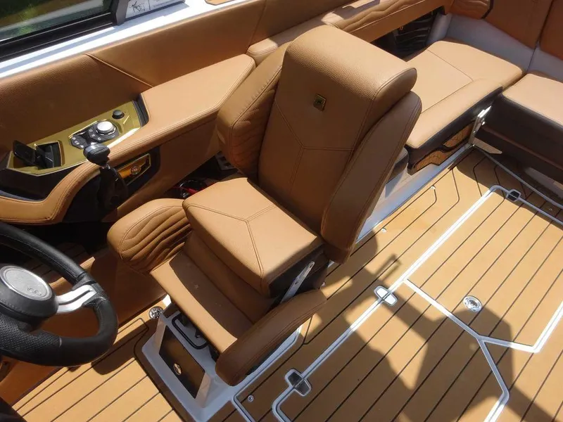 Slide: The Image of 2025 Nautique G23 interior with tan leather seats and modern dashboard design. - 17