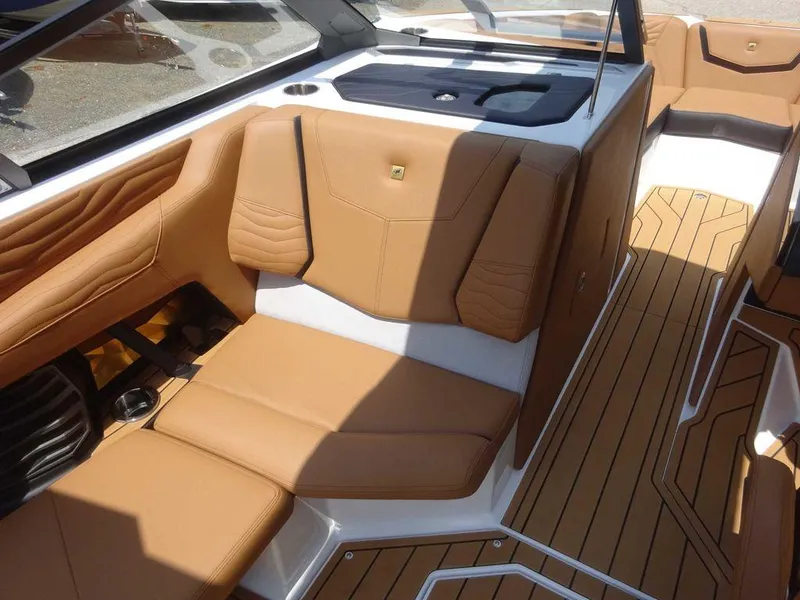 Slide: The Image of 2025 Nautique G23 boat interior with tan leather seating and teak flooring. - 6