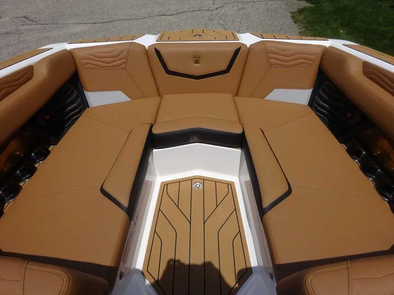 Slide: The Image of 2025 Nautique G23 boat interior with tan leather seating and sleek design. - 9