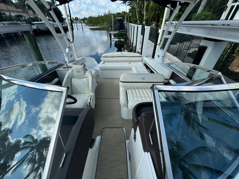 Slide: The Image of 2015 Cobalt R7 boat interior with white seating, docked by a canal. - 16