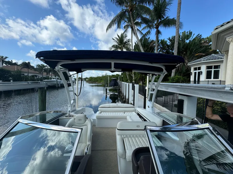 Slide: The Image of 2015 Cobalt R7 boat docked by a canal with palm trees and blue sky. - 17