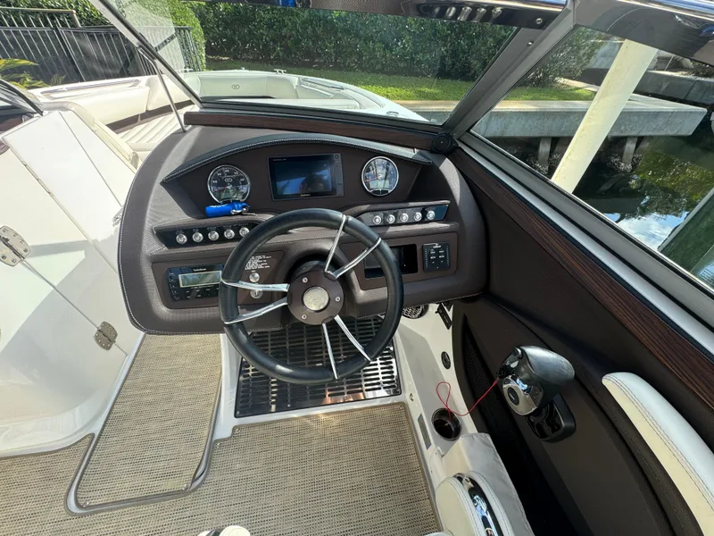 Slide: The Image of 2015 Cobalt R7 boat dashboard with steering wheel and control panel. - 18