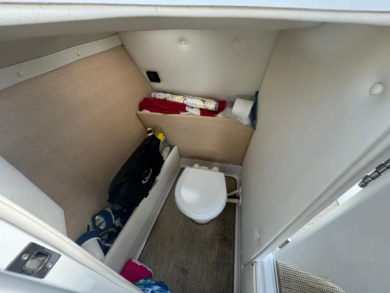 Slide: The Image of 2015 Cobalt R7 boat interior with compact bathroom and storage area. - 19