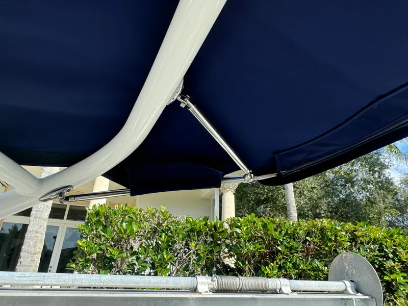 Slide: The Image of 2015 Cobalt R7 boat canopy with lush greenery in the background. - 22