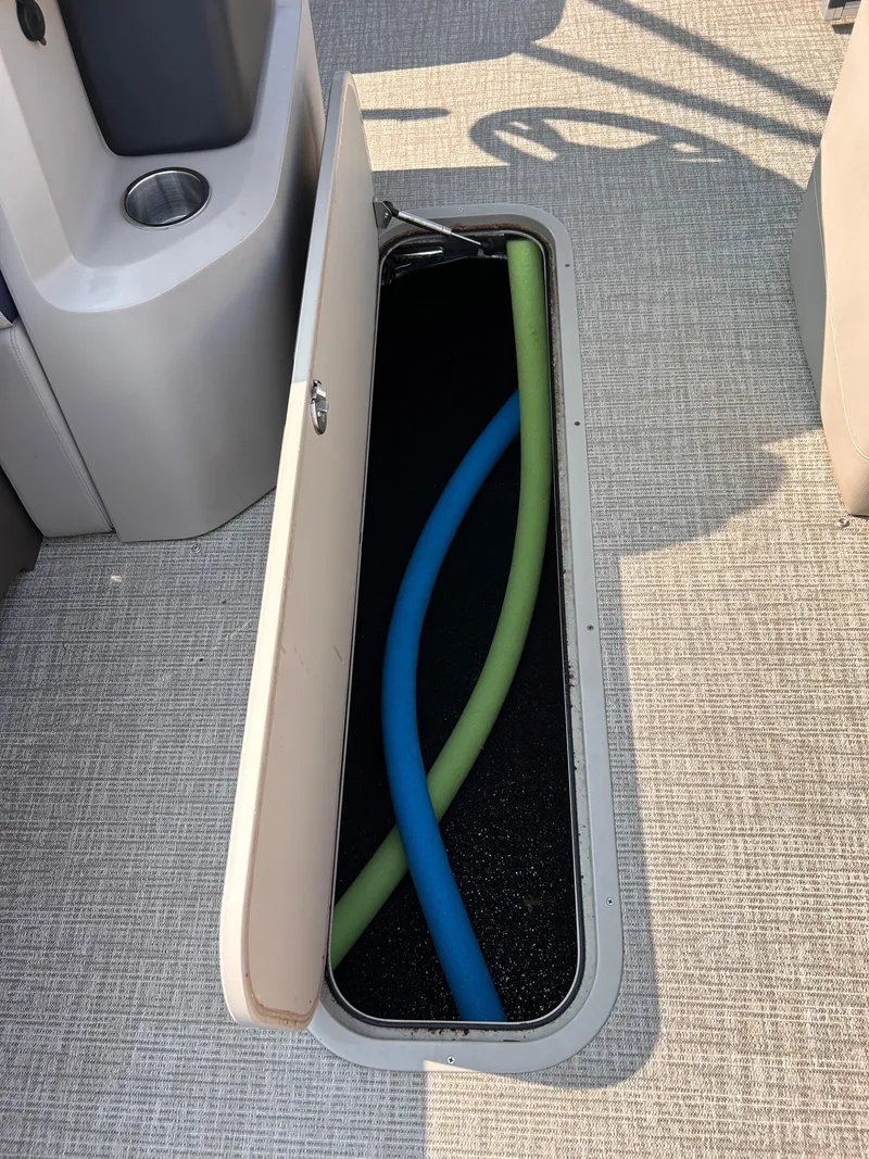 Slide: The Image of 2024 Avalon LSZ Cruise boat storage compartment with pool noodles. - 18