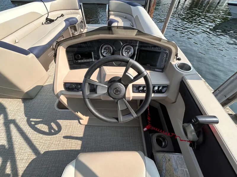 Slide: The Image of 2024 Avalon LSZ Cruise 25' boat interior with steering wheel and dashboard controls. - 21