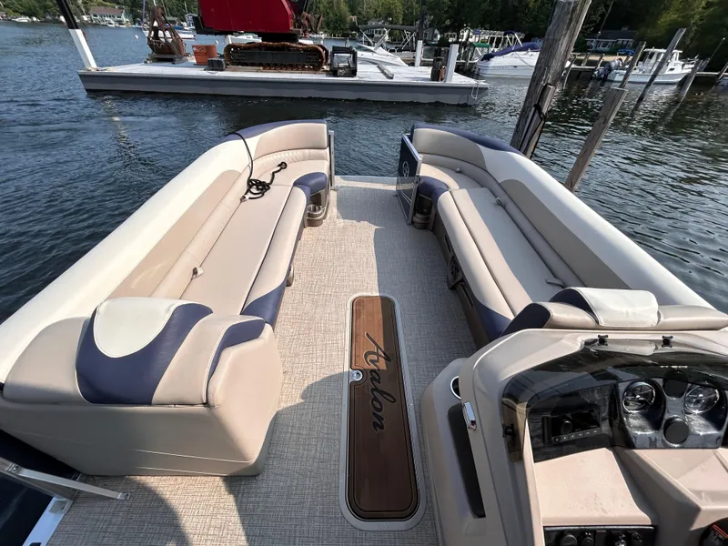 Slide: The Image of 2024 Avalon LSZ Cruise 25' pontoon boat interior with plush seating and dashboard. - 22