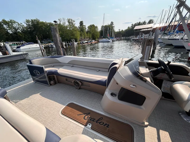 Slide: The Image of 2024 Avalon LSZ Cruise 25' pontoon boat interior at a marina. - 23