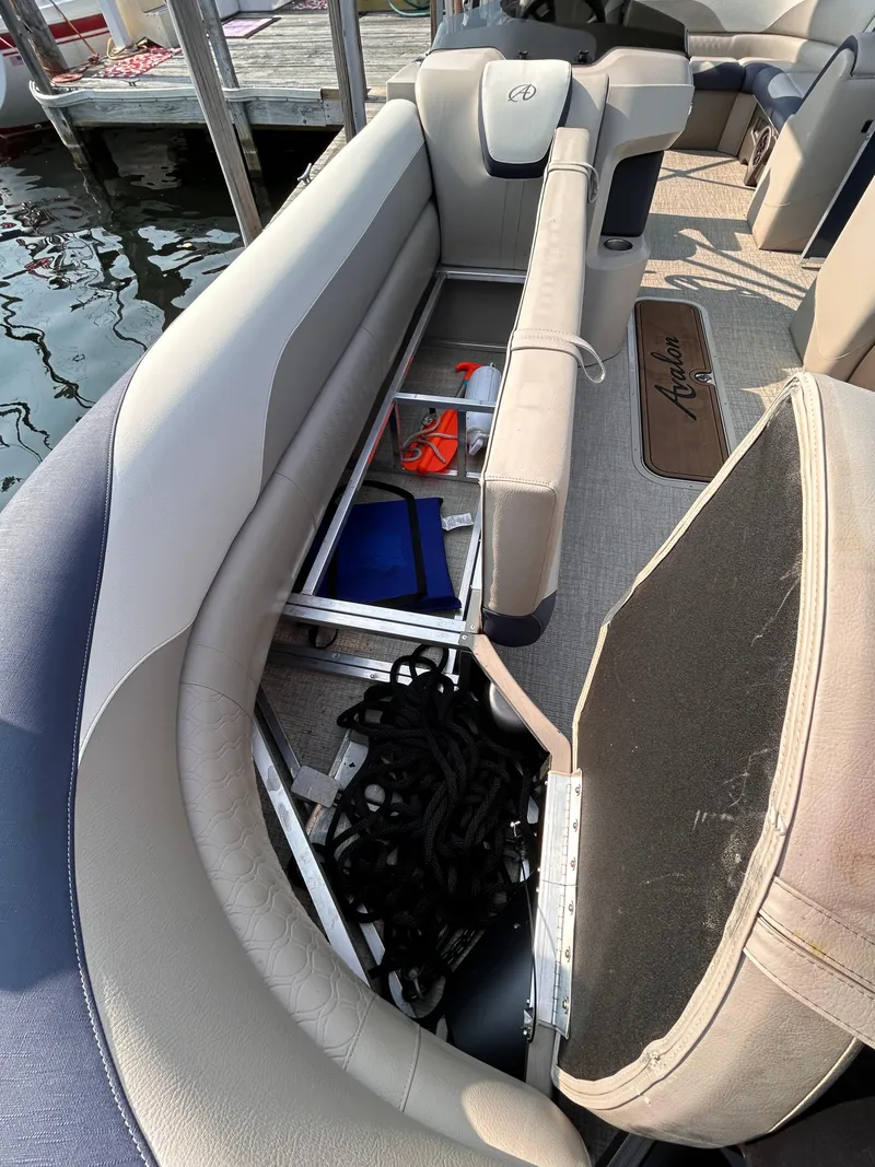 Slide: The Image of 2024 Avalon LSZ Cruise 25' boat interior with open storage compartments. - 24