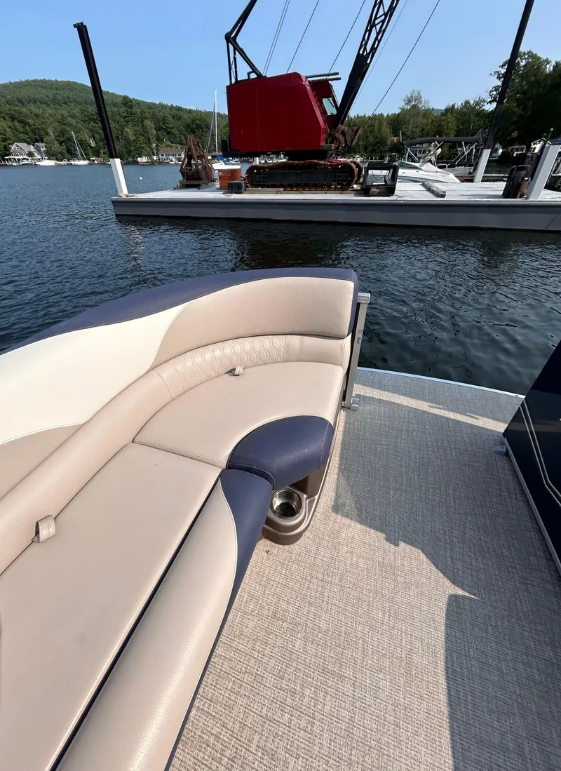 Slide: The Image of 2024 Avalon LSZ Cruise 25' boat interior with lake view and docked crane. - 27