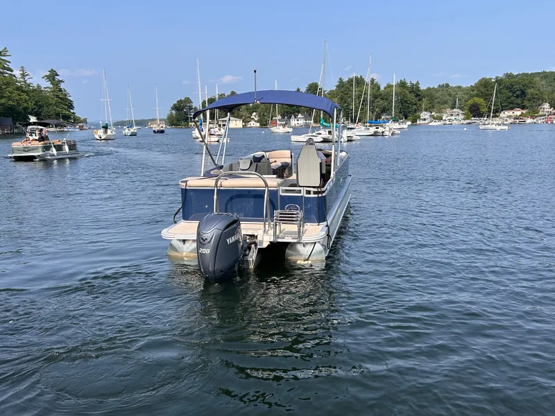 Slide: The Image of 2024 Avalon LSZ Cruise 25' pontoon boat on a scenic lake. - 3