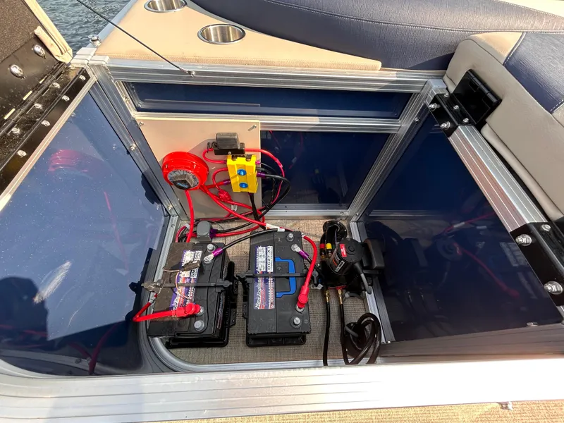 Slide: The Image of 2024 Avalon LSZ Cruise 25' boat battery compartment with wiring and components. - 8
